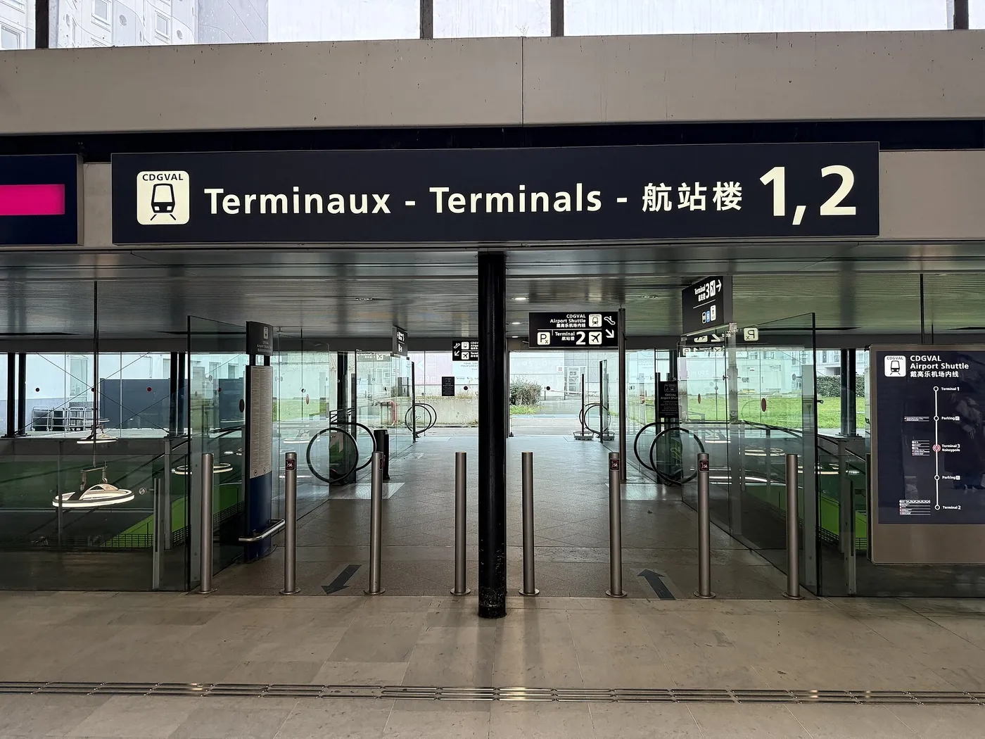 An entrance to CDGVAL at Terminal 3 Roissypole with signs for Terminals 1 and 2