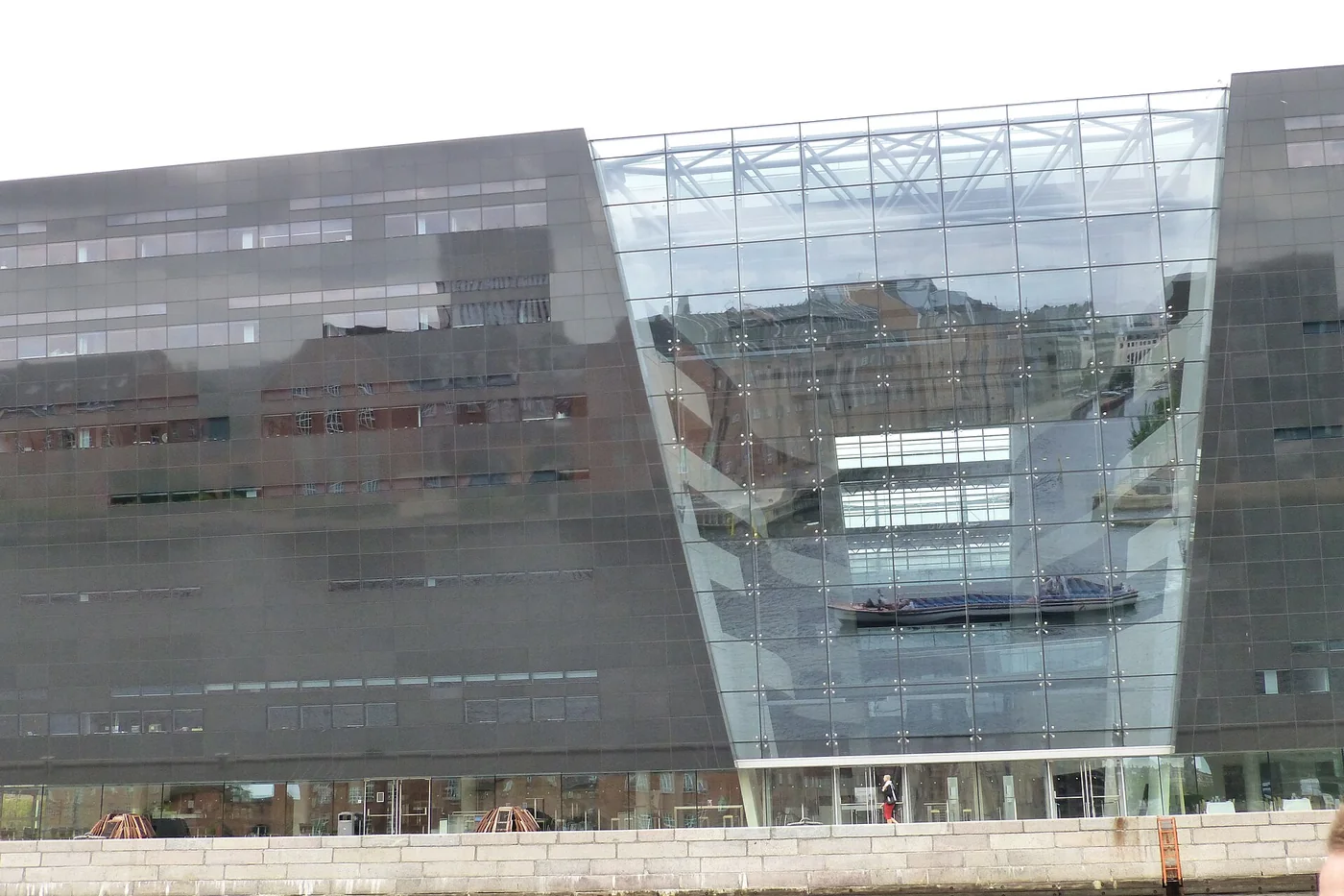 The dark glass facade of the Black Diamond library beside Copenhagen harbour