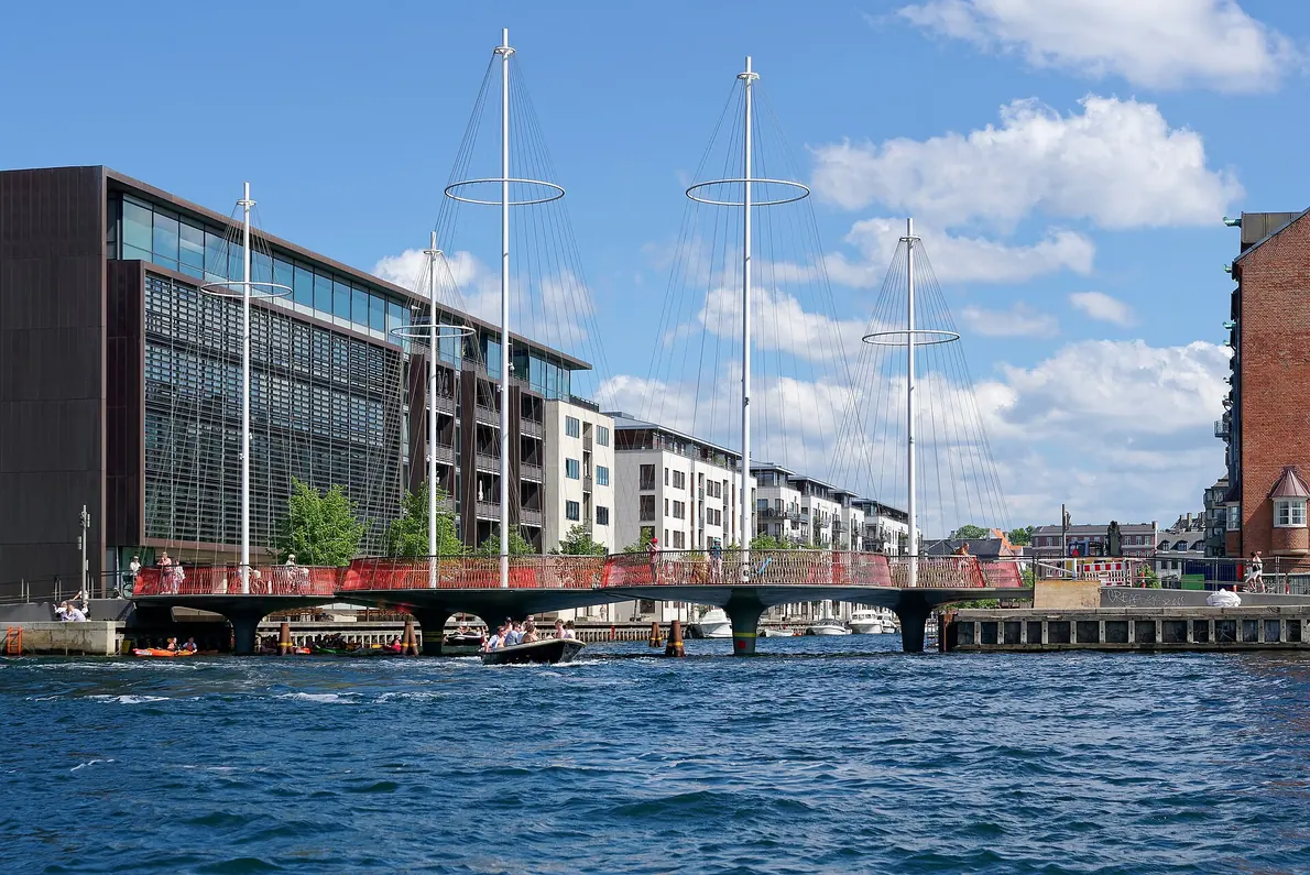 The circular decks and red rails of Cirkelbroen over a Copenhagen canal