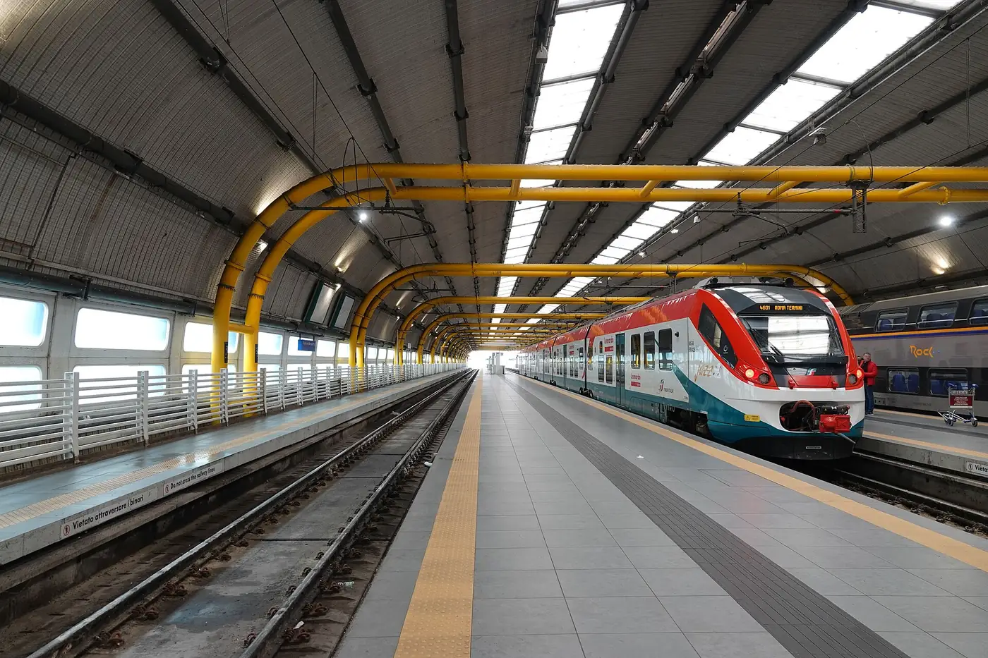 Covered railway platforms and a train at Fiumicino Aeroporto station