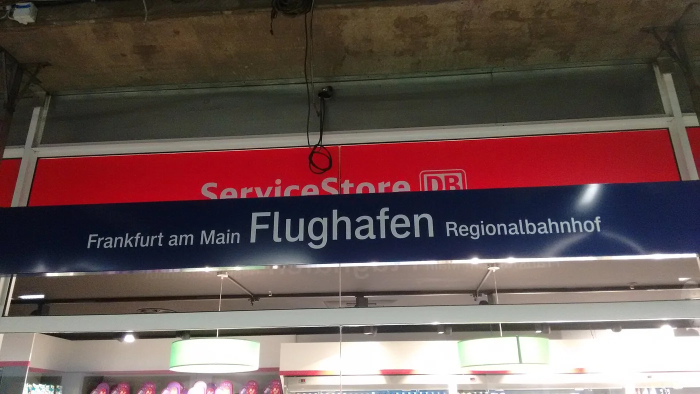A station sign reading Frankfurt am Main Flughafen Regionalbahnhof