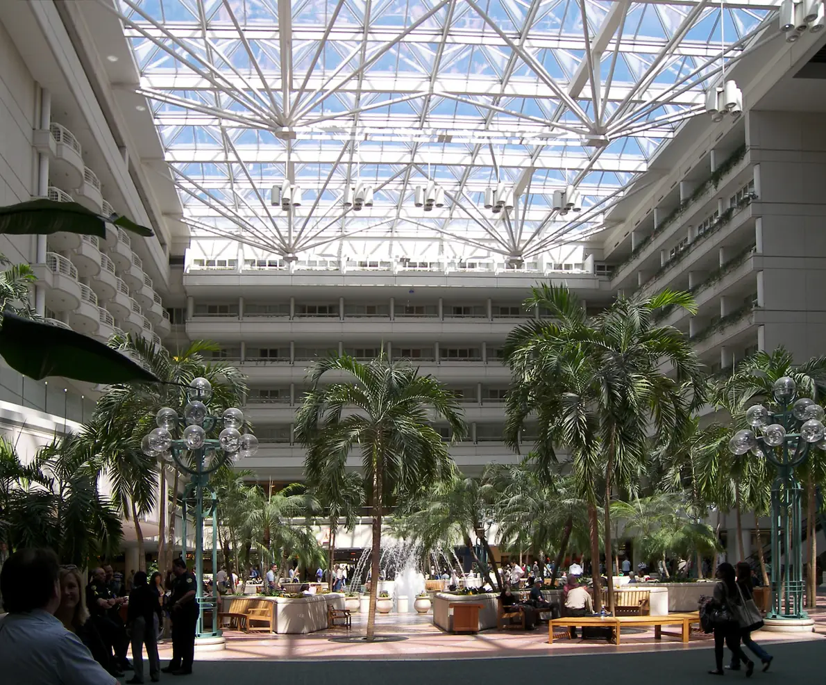 Palm trees beneath the glass roof of the Orlando International Airport atrium