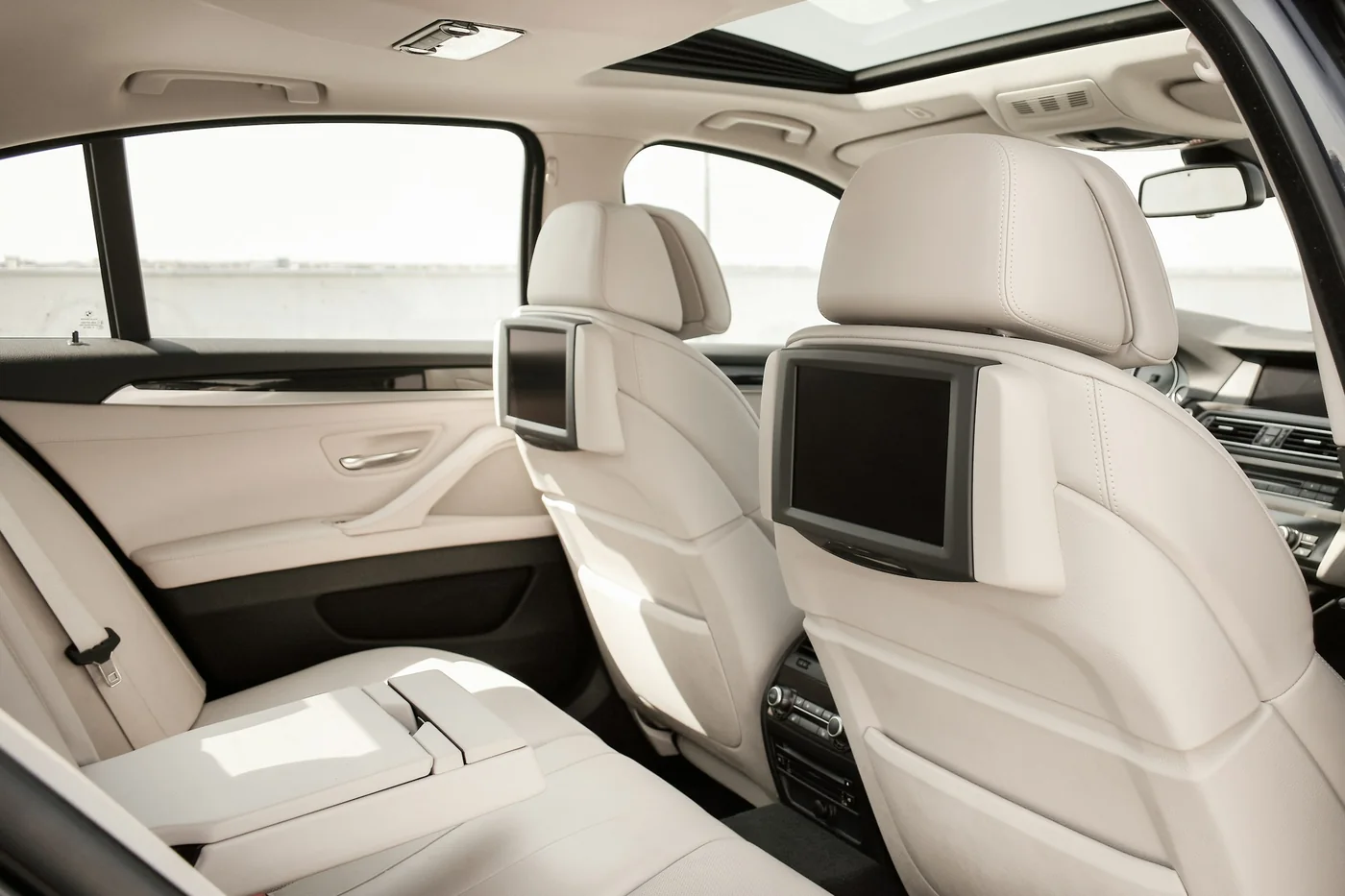 The rear passenger seats and front seatbacks inside a car